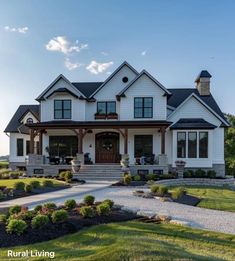 a large white house sitting on top of a lush green field