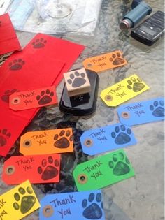 a dog paw themed thank you note with a cell phone on the table next to it