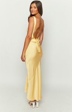 * Yellow Maxi Dress 
 * 
 
 * How to style: 
 * This dress () is the perfect mix of classy and chic. The satin material creates a sheer look with the simplistic detailing bound to make you fall in love. Complete the look with dainty jewellery () and white heels ()!  
 * 
 
 * Features:    
 * Lightweight 
 * Maxi length 
 * Little to no stretch 
 * Pull on style 
 * Wrap around strings either side 
 * Bias cut Dainty Jewellery, Prom Midi Dress, Yellow Maxi Dress, 60's Dress, Yellow Maxi, Yellow Satin, Beginning Boutique, Satin Maxi, White Heels