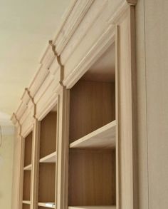 an empty bookshelf in the corner of a room