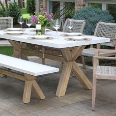 a white table and some chairs on a patio