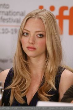 a beautiful blonde woman sitting at a table