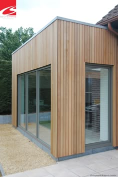 a wooden building with sliding glass doors on the outside