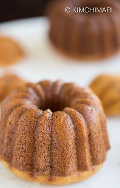 a bundt cake sitting on top of a white counter next to other bundt cakes