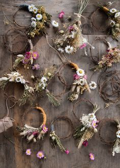 dried flowers are laid out on a wooden surface with twine and rope around them