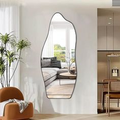 a living room filled with furniture and a large mirror hanging on the wall above it