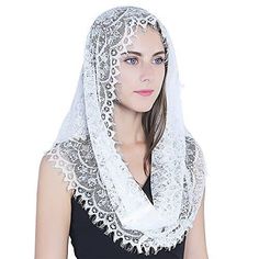 a woman wearing a white scarf with lace on it