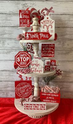 a red and white christmas tree made out of wooden signs on top of a table