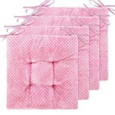 four pink towels with ties on them