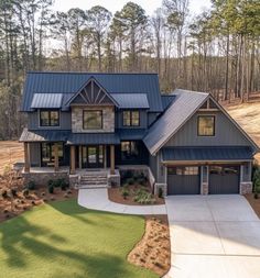 a large house in the woods with lots of windows