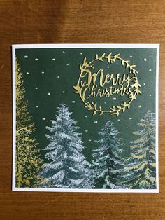 a merry christmas card with pine trees and snow