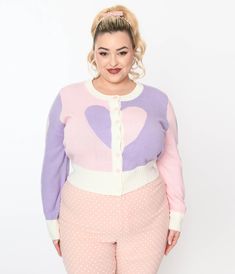 This charming plus size cardigan is crafted in a sweater knit in light pink and lavender and boasts a contrasting heart design. Outfitted with a scoop collar, secured by a button down closure, and complete with long sleeves.Available in sizes XS/S-4X/5X while supplies last. Plus Size Coquette, Hearts Cardigan, Plus Size Mini Skirt, Plus Size Cardigan, Plus Size Pink, 1960s Inspired, Heart Cardigan, Lavender Heart, Pink And Lavender