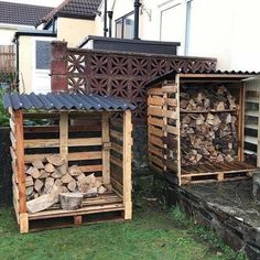 two wooden boxes with firewood stacked in them next to each other on the grass