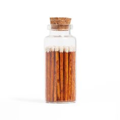 cinnamon sticks in a glass jar on a white background