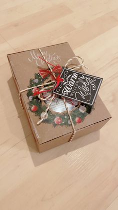 an open christmas gift box sitting on top of a wooden floor