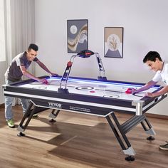 two young men playing a game of air hockey