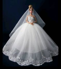 a barbie doll wearing a wedding dress and veil