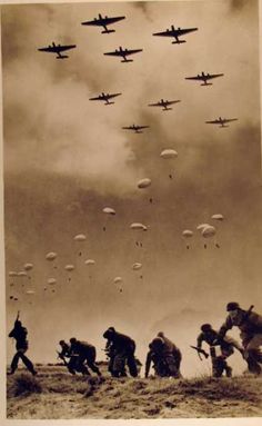 a group of men walking across a field next to an airplane flying in the sky