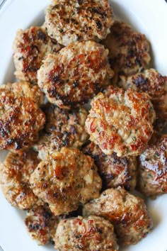 some meatballs are on a white plate and ready to be eaten by someone else