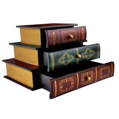 three books stacked on top of each other with gold trimmings and decorative designs