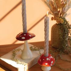 two candles sitting on top of a wooden table