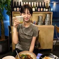 a woman sitting at a table with food in front of her