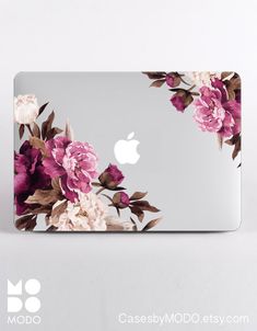 an apple laptop with pink flowers on it