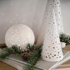 two white christmas trees on top of a book