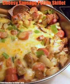 a skillet filled with cheese sausage and potatoes