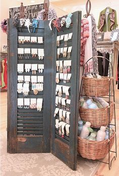 an open display case in a store filled with clothes and other items, including baskets