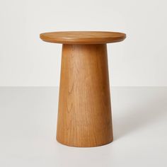 a small wooden table sitting on top of a white floor