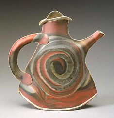 a red and gray vase with a spiral design on it