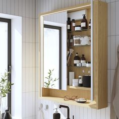 a wooden medicine cabinet sitting next to a bathroom sink