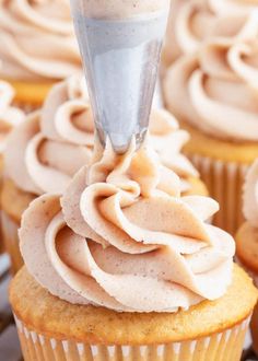 cupcakes with frosting being piped into the icing