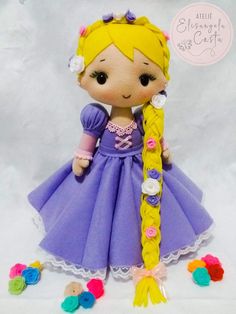 a doll with long blonde hair wearing a purple dress and some colorful buttons on it