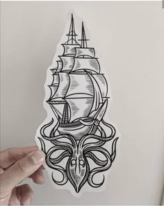 a sticker with an octopus and ship on it's side, in black ink