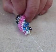 someone is working on something with beads