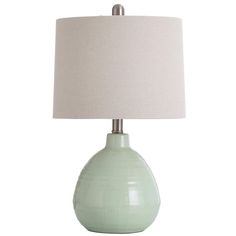 a light green table lamp with a white shade