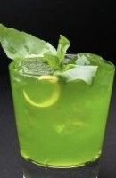 a green cocktail with lime and mint garnish