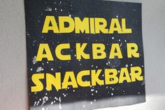 there is a sign on the wall that says admiral ackbar snack bar in yellow