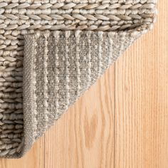 an area rug on top of a wooden floor next to a wood flooring board