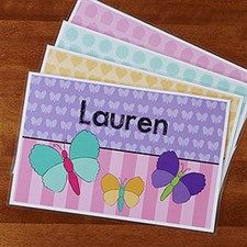 three cards with butterflies on them and the word lauren written in large letters, sitting on a wooden surface