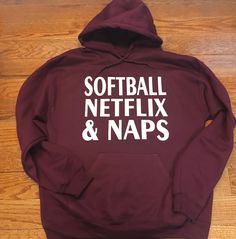 a maroon sweatshirt with the words softball netflix and naps printed in white on it