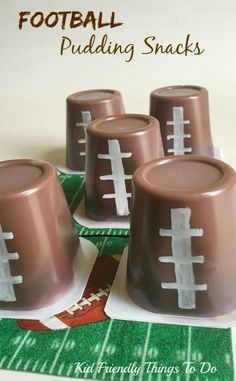 four football puddinging snacks sitting on top of a table