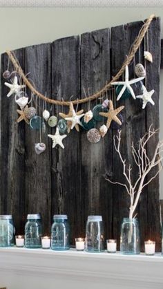 the mantle is decorated with mason jars and seashells