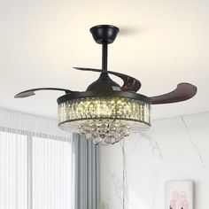 a living room with a ceiling fan and chandelier