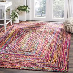 a multicolored area rug in front of a door