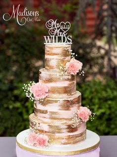 a wedding cake with pink flowers on top