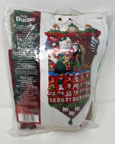 the back of a bag with santa claus on it and other christmas items in it