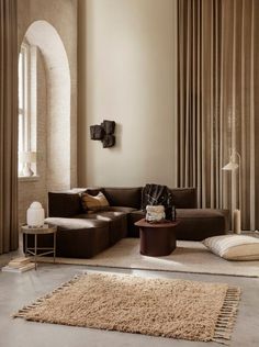 a living room filled with lots of furniture next to a wall mounted clock and window